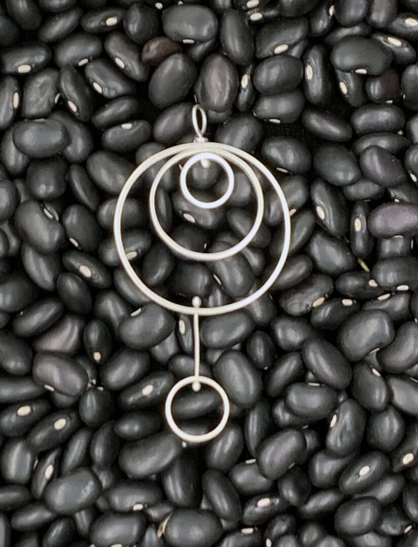 Three interlocking Ring pendant with small dangling ring